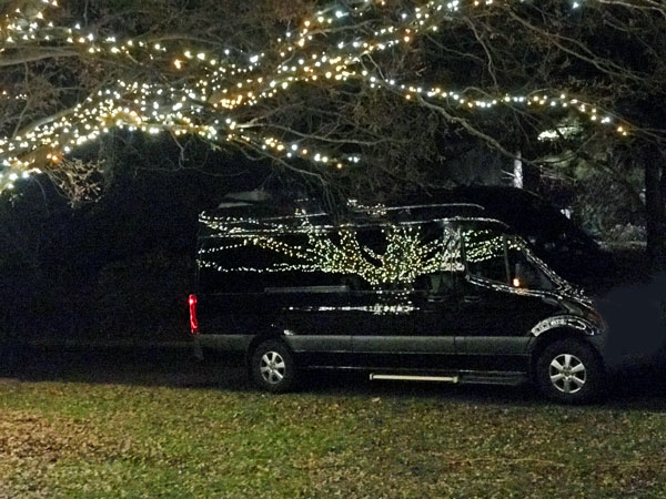 van with reflecting Christmas lights